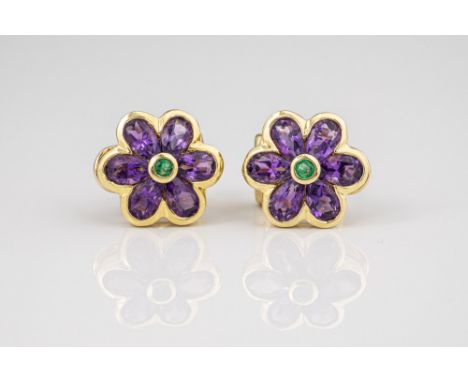 A pair of 18ct gold, amethyst and emerald flower earrings, each six petalled flower set with six pear cut amethysts and a cen