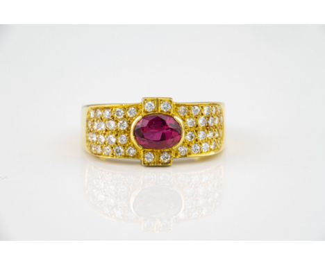 An 18ct yellow gold, ruby and diamond ring, the oval cut ruby within a shaped border, pavé set with brilliant cut diamonds, s