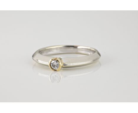 A 9ct yellow and white gold solitaire diamond ring, with a 0.10ct brilliant cut stone, on a bladed shank, ring size L½. 