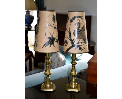 A pair of 19th century brass candlestick lamps, converted to electricity, with shades. (2)