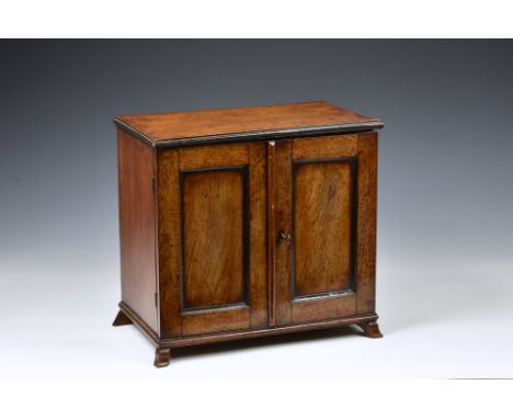 A mid-19th century mahogany apprentice piece cabinet, the cabinet with two panelled doors and shaped bracket feet, the interi