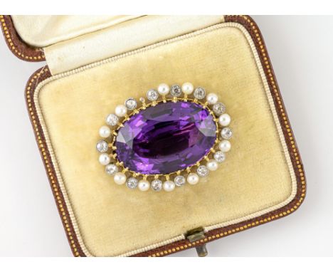 A fine Edwardian 18ct yellow gold, platinum, amethyst, seed pearl and diamond brooch, the large 26 x 17.5mm. oval cut amethys