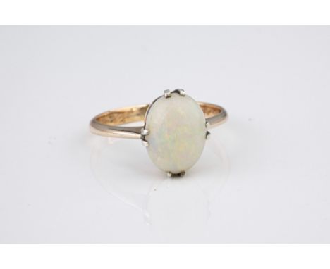 A vintage 9ct yellow gold and opal ring, with a claw set cabochon 11 x 8.5mm. white opal, size P.