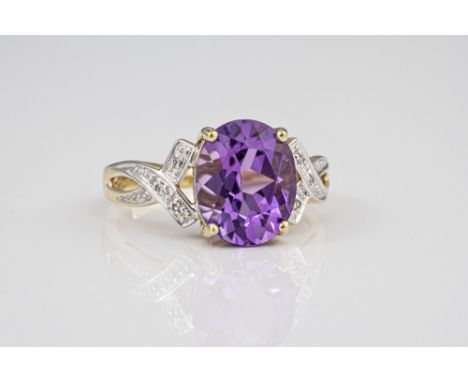 A 9ct yellow gold, amethyst and diamond ring, the oval cut amethyst over pierced twist shoulders set with eight cut diamonds,