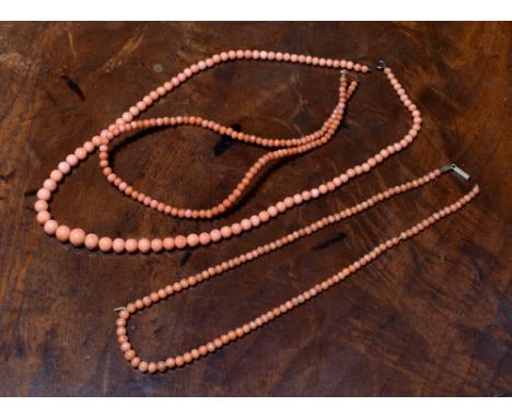 Three vintage pink coral bead necklaces, early 20th century, comprising a graduated bead necklace, 3mm. to 7mm., clasp a/f; a