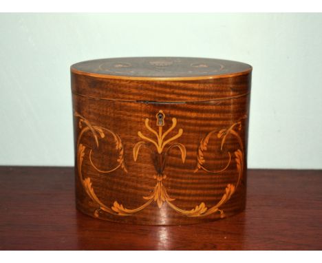 A George III mahogany and marquetry oval tea caddy, the hinged lid with marquetry urn and foliate scrolls, over a conforming 