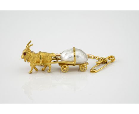 A Victorian 18ct gold, ruby and baroque pearl goat cart brooch, the miniature goat with ruby set eyes, pulling a cart with re