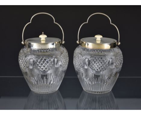 A pair of attractive George V cut glass silver mounted biscuit barrels with swing handles, Henry Williamson Ltd, Birmingham, 