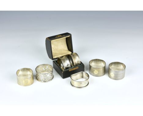 A small collection of silver napkin rings, comprising a boxed pair, Chester 1914; an engine turned pair by E. J. Trevitt & So
