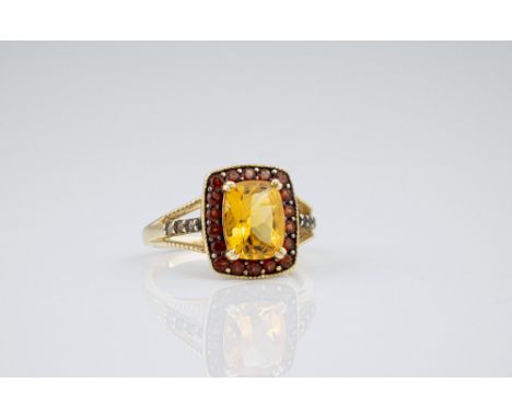 A 14ct yellow gold and orange topaz cluster ring, the cushion cut orange topaz within a border of round cut dark orange topaz