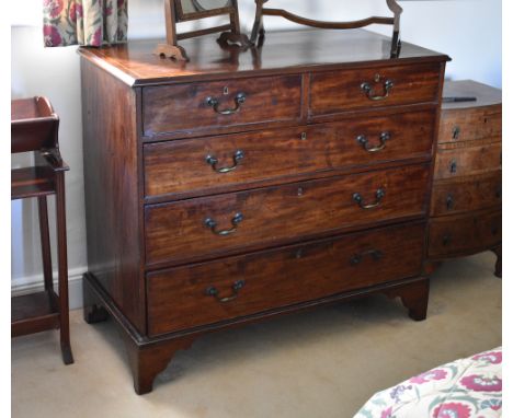 A George III mahogany straight front chest, the cross banded and barber's pole banded top over two short and three long gradu