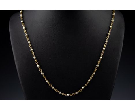 A vintage 9ct gold and seed pearl necklace, 20¼in. (51.5cm.) long.