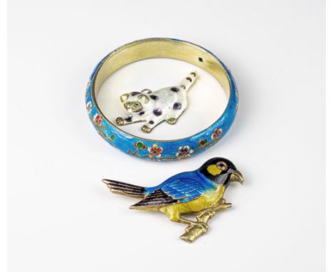 A Chinese enamelled silver-gilt bangle, unmarked, decorated with a floral spray on blue ground, together with two enamel broo