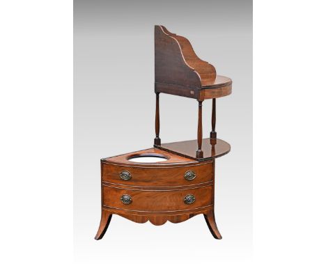 An unusual George III metamorphic mahogany corner washstand, the shaped top with later shelf, raised on turned supports, the 