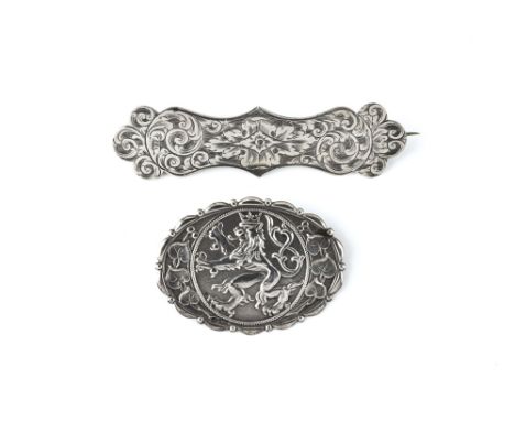 A Victorian chased silver brooch, shaped label form with all over foliate chased decoration, 7cm. long; together with an oval