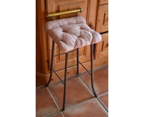 A vintage French cast iron and brass bar stool with buttoned seat., 