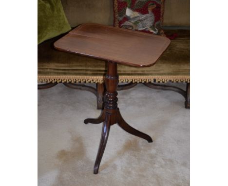 A late Regency mahogany tilt-top tripod table, the boxwood strung rounded rectangular top on a turned baluster column, on thr