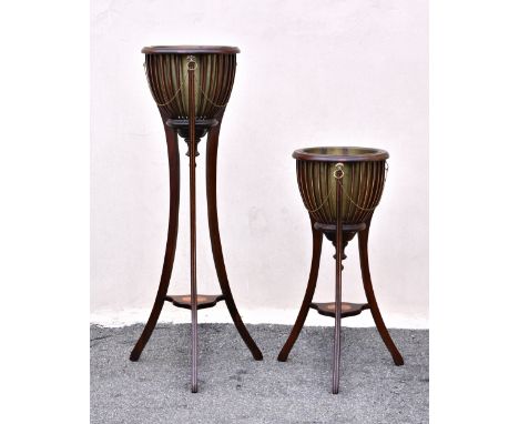 A graduated pair of George III style inlaid mahogany basket top jardinière stands, second half 20th century, with painted str
