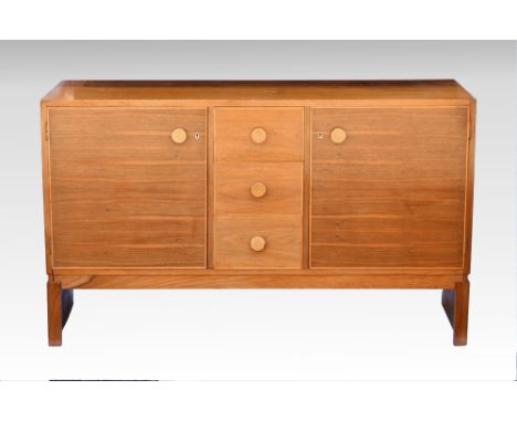 A teak side cabinet by Gordon Russell Ltd., 1950s-60s, the plain top over a central bank of three drawers, flanked by cupboar