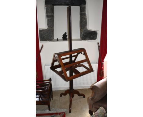 A Victorian mahogany adjustable library bookstand, the angled, slatted sides with Turkish arched pierced brackets, on a turne