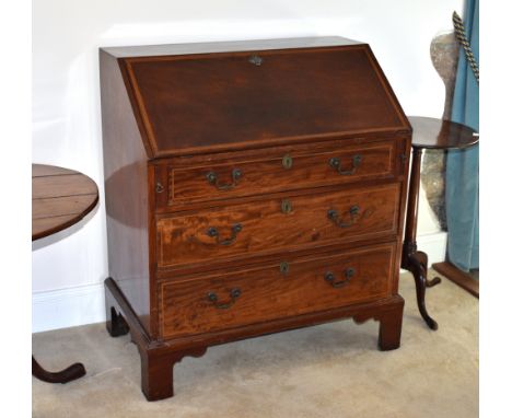 A George III inlaid mahogany bureau, c.1810, the fall front with inlaid Greek key border, enclosing a fitted interior with pa