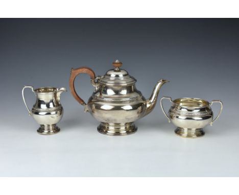 A George V silver three piece tea service, Adie Brothers Ltd, Birmingham, 1930, comprising a teapot, twin handled sugar bowl 