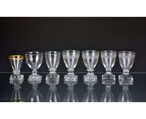 A group of seven late Georgian square base dram glasses, including two pairs, one with engraved trefoil decoration and lemon 