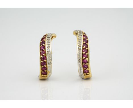 A pair of 9ct yellow gold, ruby and diamond hoop earrings, the twist loops set with a row of round cut rubies and three eight