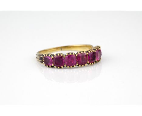 A 19th century 15ct gold and ruby ring, the seven cushion cut rubies within millegrain borders, ring size P.* Condition: Shan