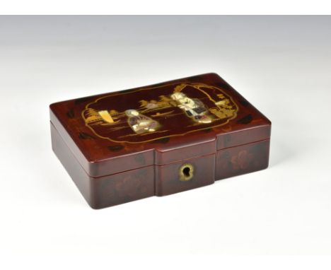 A Japanese red lacquer box, 20th century, of shaped rectangular form, the hinged cover decorated with relief mother-of-pearl 