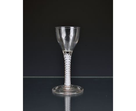 A Georgian air twist wine glass, circa 1750, the ogee bowl on multi spiral opaque twist stem, consisting of pair of spiral th