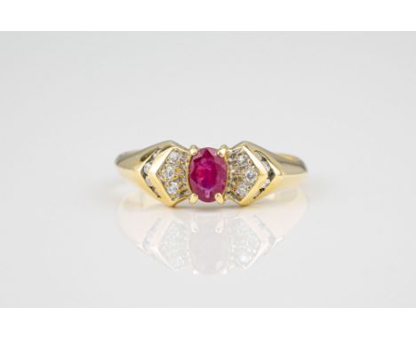 An 18ct yellow gold, ruby and diamond ring, the central oval cut ruby over shoulders each set with seven small diamonds, size