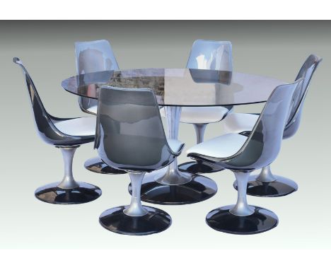 A 1970s Chromecraft Saarinen Tulip dining table set, the oval smoked glass top on a flared aluminium pedestal and smoked luci