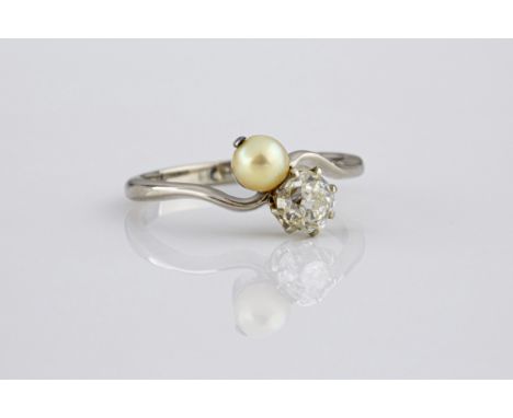 An 18ct white gold, pearl and diamond twist ring, 1930s, with a single old cut diamond and cultured pearl, size K½.