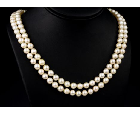 A two string cultured pearl necklace, the evenly sized 7mm. pearls with a 9ct gold, garnet and seed pearl star clasp, hallmar