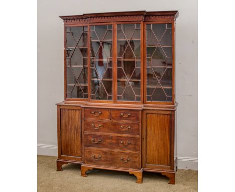 A George III Hepplewhite style mahogany breakfront library bookcase, of small proportions, the dentil carved and arcaded corn