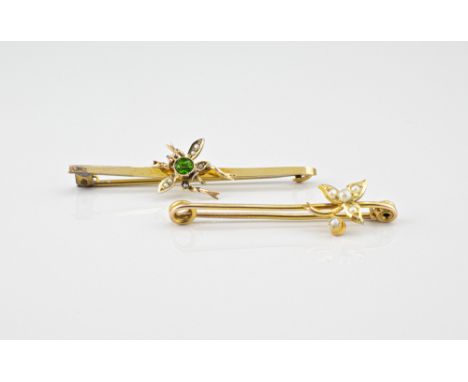 Two cased antique 9ct gold bar brooches, one with a green gem set and seed pearl fly, the other with a seed pearl set leaf. (