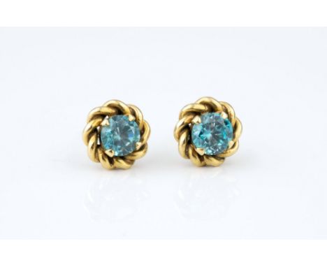 A pair of vintage 9ct gold and zircon stud earrings, 1950s, the round cut zircons within rope twist borders. (2)* Condition: 