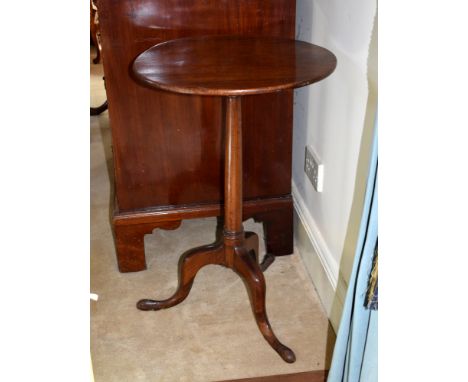 A George III mahogany tripod table, the plain circular top on a slender tapered turned column, to three cabriole legs with pa