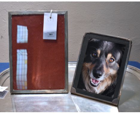 Two silver mounted easel back photo frames, comprising an Art Deco photo frame of shaped rectangular form with engine turned 