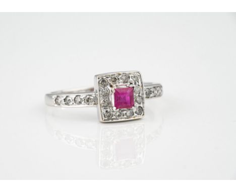 A 14ct white gold, ruby and diamond cluster ring, the square cut natural ruby within a border of brilliant cut diamonds, over