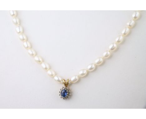 A 9ct gold, sapphire, diamond and pearl necklace, the oval cut sapphire within a cluster of single cut diamonds, on a freshwa