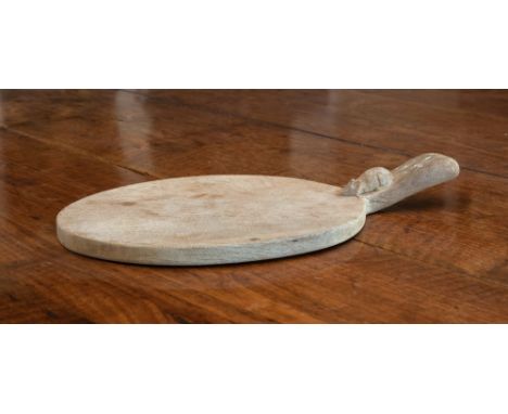 A Robert Mouseman Thompson of Kilburn carved oak cheese or bread board, oval form with carved mouse to the shaped handle, 15¾