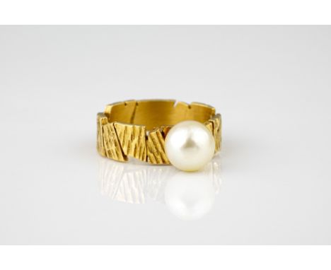 A 22ct gold and cultured pearl ring, the irregular, bark effect band set with a single cultured pearl, size L.