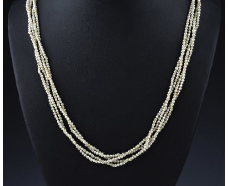 A vintage seed pearl choker necklace, four strand, with silver clasp, 19¾in..) long.