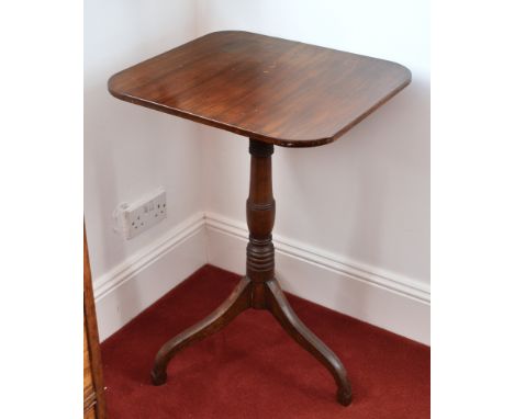 A mid-19th century mahogany tilt-top tripod table, the rounded rectangular top on a turned baluster column, raised on swept s