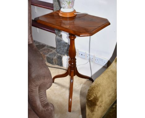 A mid-19th century mahogany tilt-top tripod table, the octagonal moulded top on a turned baluster column to three swept suppo