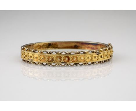 A Victorian 15ct gold bangle, the hinged bangle with beaded and rope twist decoration and conforming pierced borders, unmarke