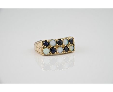 A vintage 9ct yellow gold, opal and sapphire ring, with two rows of alternate round cut sapphires and round cabochon opals, o