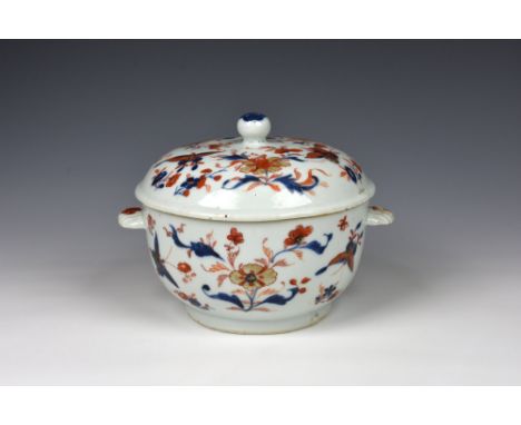 A Chinese porcelain Imari decorated covered dish, 18th century, the circular cupped dish with twin, fluted semi-circular hand